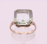 An unmarked white metal solitaire aquamarine ring. Ring size P.