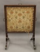 A 19th century mahogany tapestry inset fire screen. 61 cm wide.