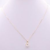 A 9 ct gold and cubic zirconia pendant on a 9 ct gold chain.