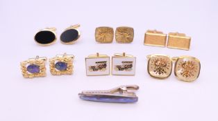 Six pairs of cufflinks and a tie clip. Car motif cufflinks 2 x 1.5 cm.