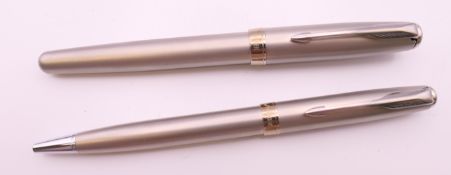 Two Parker pens in a leather case, one a ballpoint pen, the other a fountain pen.