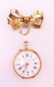 An 18 k gold cased fob watch with gold plated bow. Watch 2.5 cm diameter, bow 3 cm long.