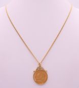 A 1911 half sovereign on a 9 ct gold chain and mount. Chain 50 cm long. 9 grammes total weight.