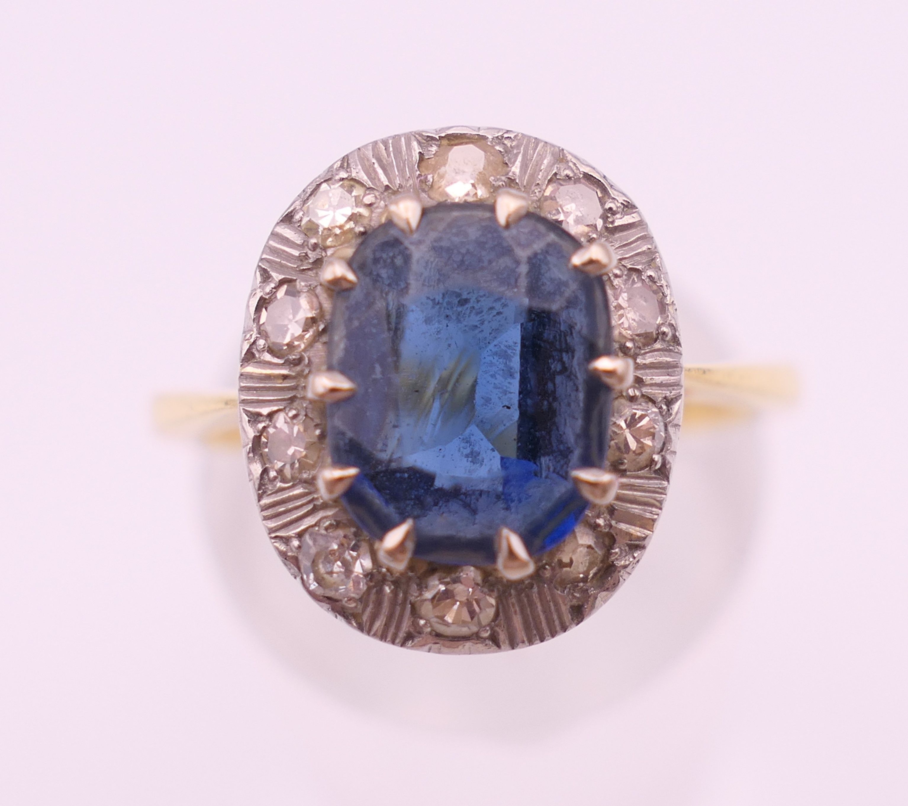 An unmarked gold sapphire and diamond ring. Ring size M/N. 4.2 grammes total weight. - Image 2 of 6