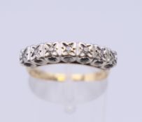 A 9 ct gold seven stone diamond ring. Ring size N/O. 2.5 grammes total weight.