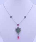 An Art Nouveau style drop pendant on a silver chain. Chain 46 cm long, pendant 5.5 cm high.