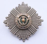A military cap badge. 5 cm diameter.