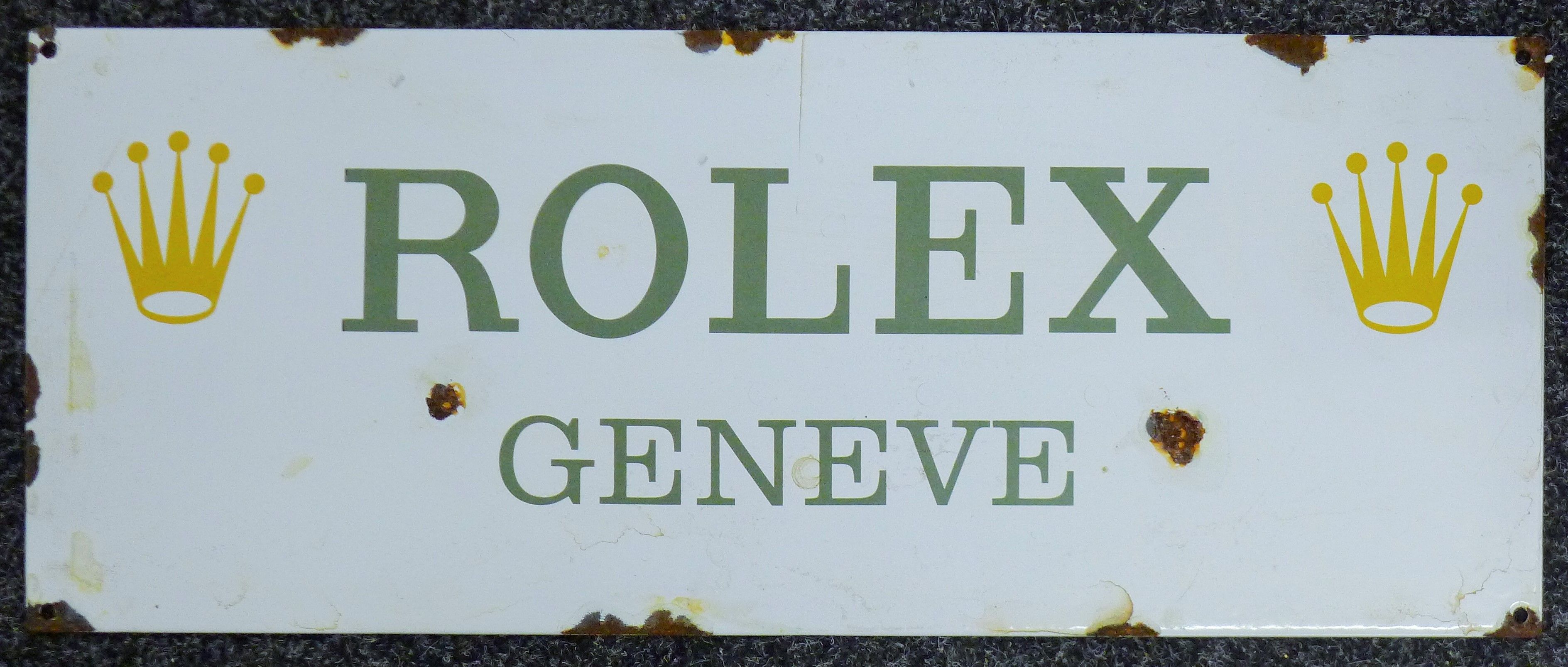 A Rolex enamel sign. 58 x 23 cm.