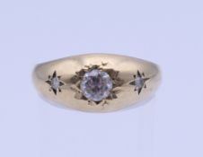 A 9 ct gold gentleman's gypsy set three stone ring. Ring size T. 4 grammes total weight.