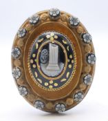 A Victorian mourning brooch with cameo roundels. 4.5 cm high.