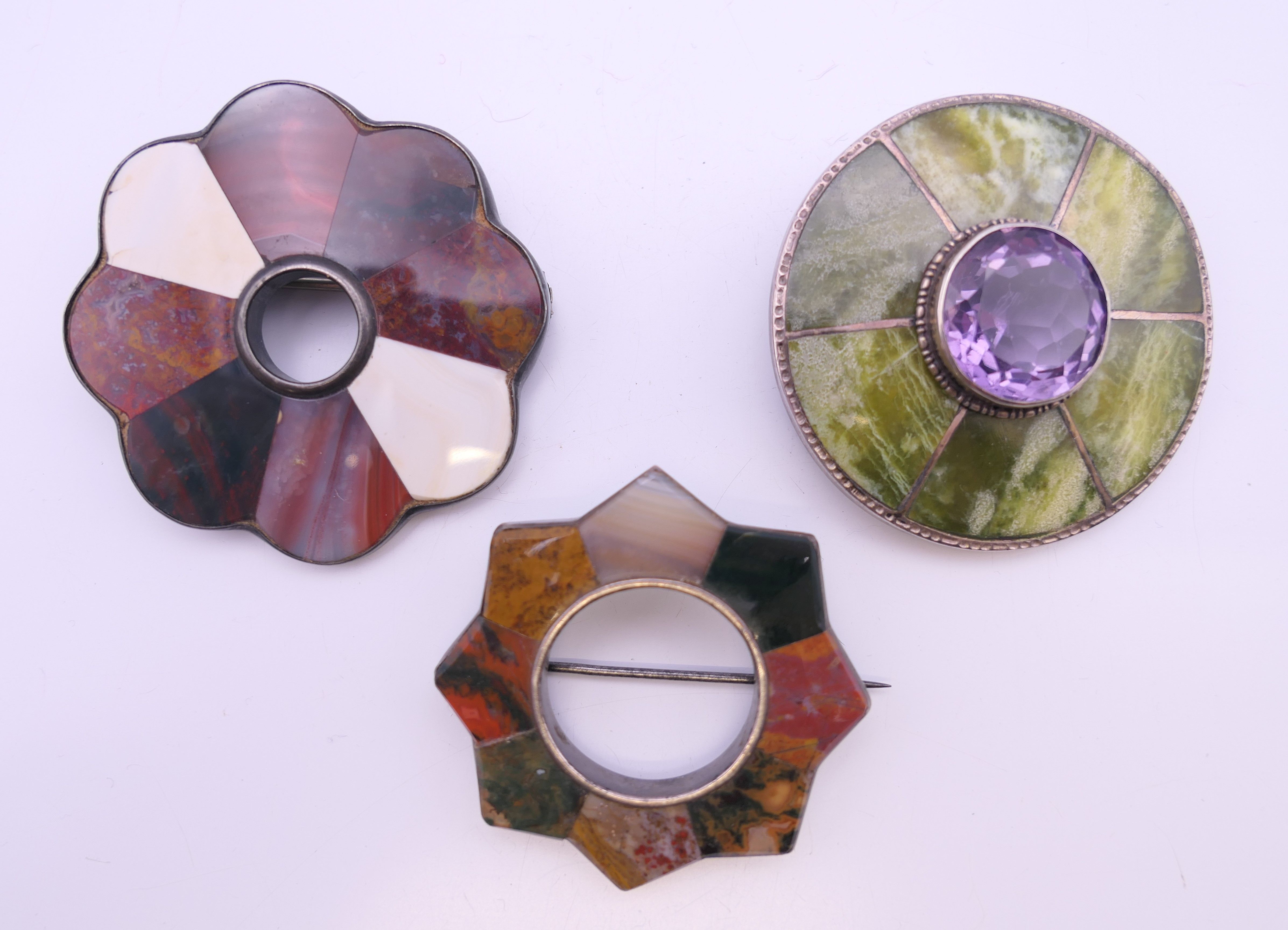 Three Scottish agate brooches. Two 5 cm diameter, the other 4.5 cm diameter.