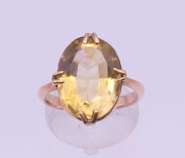 A 9 ct gold citrine ring. Ring size I/J. 4.4 grammes total weight.