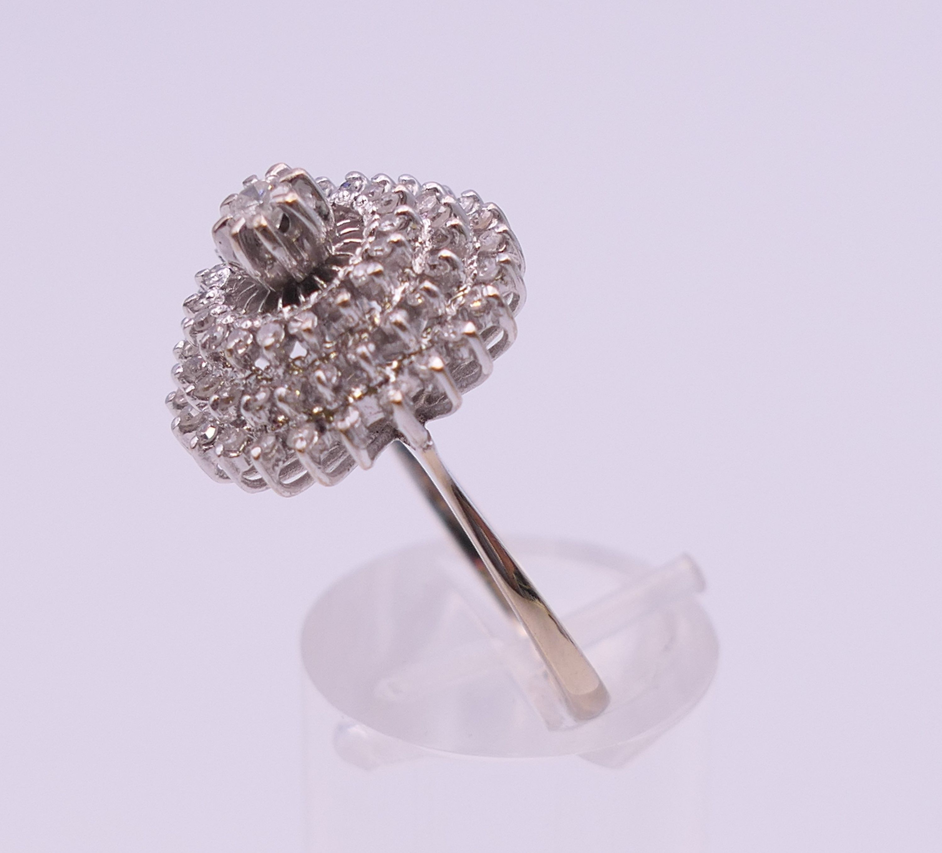 An 18 ct white gold diamond cluster ring. Ring size O. 6.3 grammes total weight. - Image 7 of 12