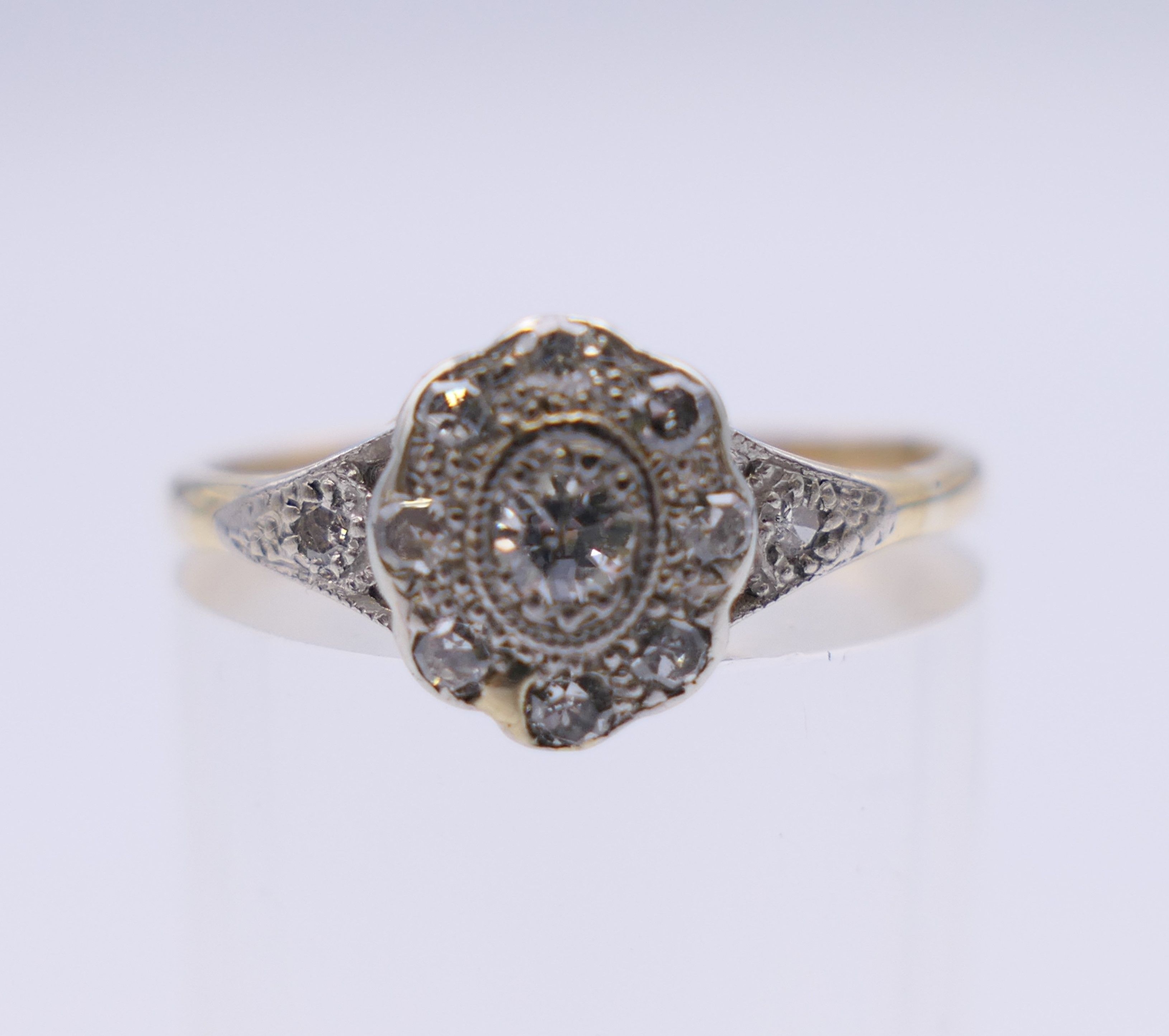 An Edwardian 18 ct gold oval diamond cluster ring. Ring size M. 2.3 grammes total weight. - Image 2 of 8