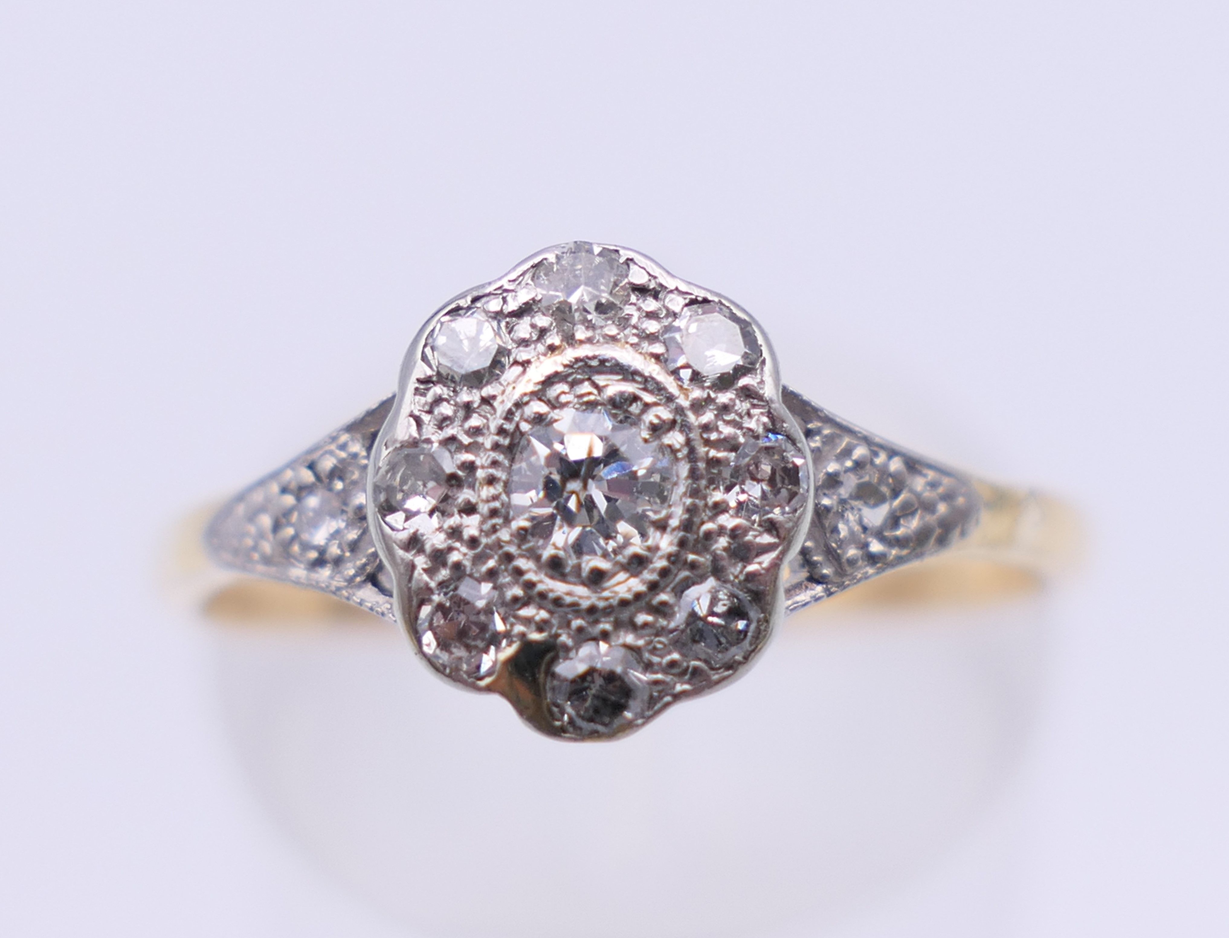 An Edwardian 18 ct gold oval diamond cluster ring. Ring size M. 2.3 grammes total weight. - Image 3 of 8