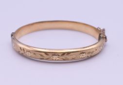 A 1/5th 9 ct rolled gold bangle form bracelet. 6.5 cm wide. 11 grammes total weight.