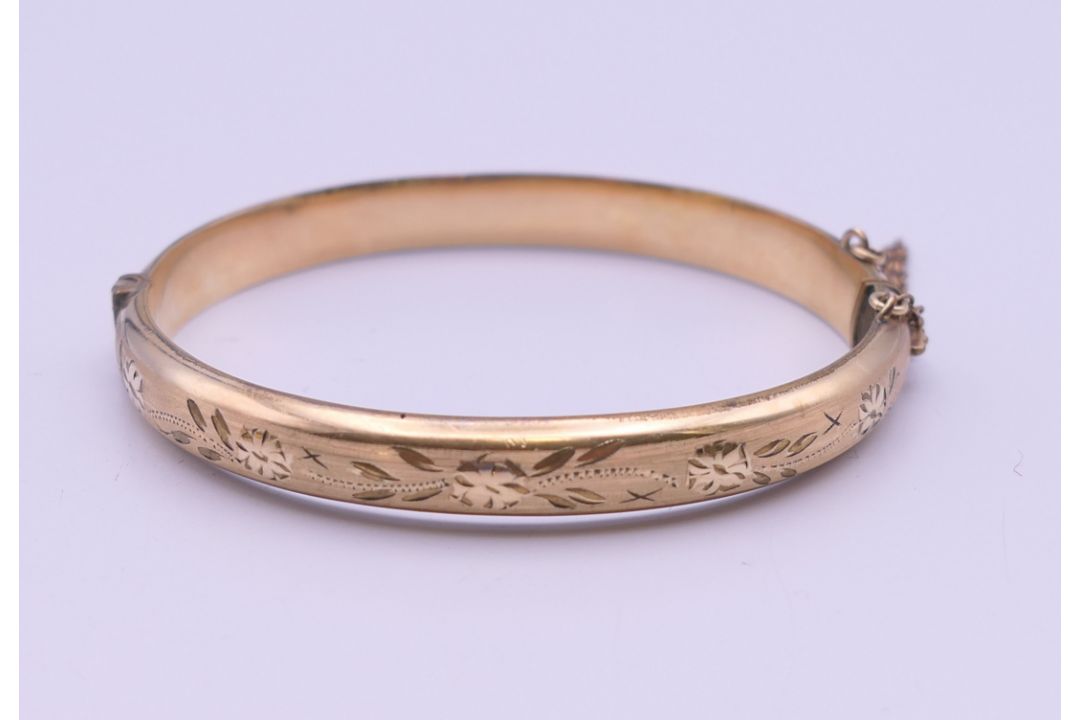A 1/5th 9 ct rolled gold bangle form bracelet. 6.5 cm wide. 11 grammes total weight. - Image 1 of 8