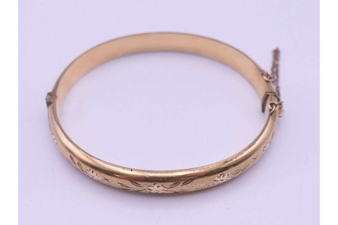 A 1/5th 9 ct rolled gold bangle form bracelet. 6.5 cm wide. 11 grammes total weight. - Image 2 of 8