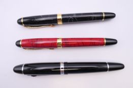 Three various fountain pens.