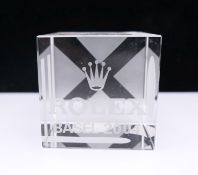 A Rolex glass paperweight. 5 cm wide.