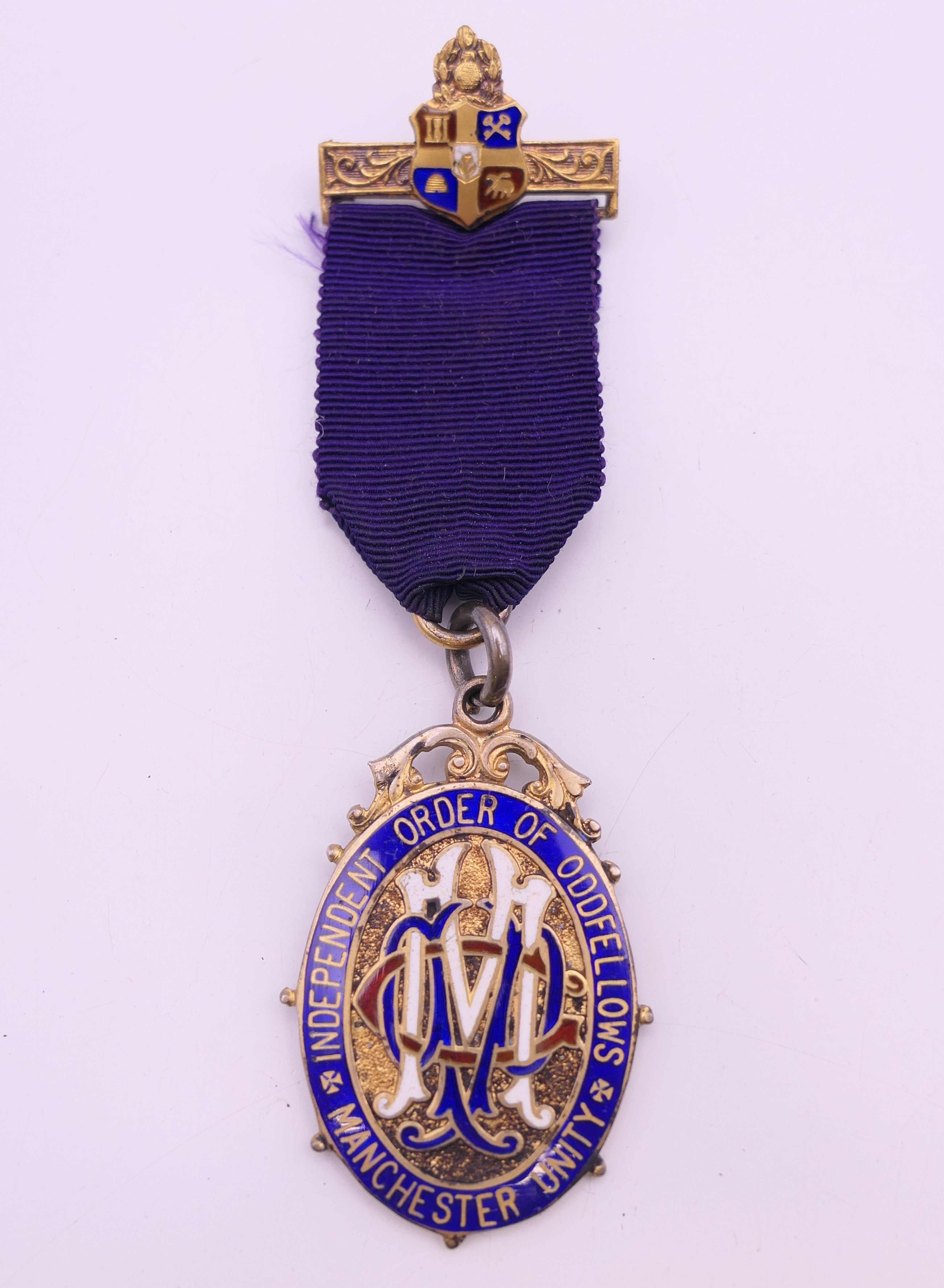 A boxed silver gilt and enamel Independent Order of Oddfellows Manchester Unity medal.