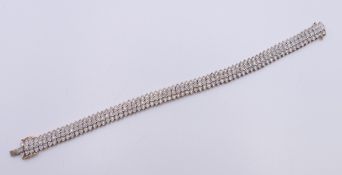 A 9 ct gold diamond bracelet. Approximate total diamond weight 2 carats plus. 18.5 cm long. 20.
