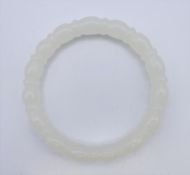 A white jade bangle. 6 cm interior diameter.