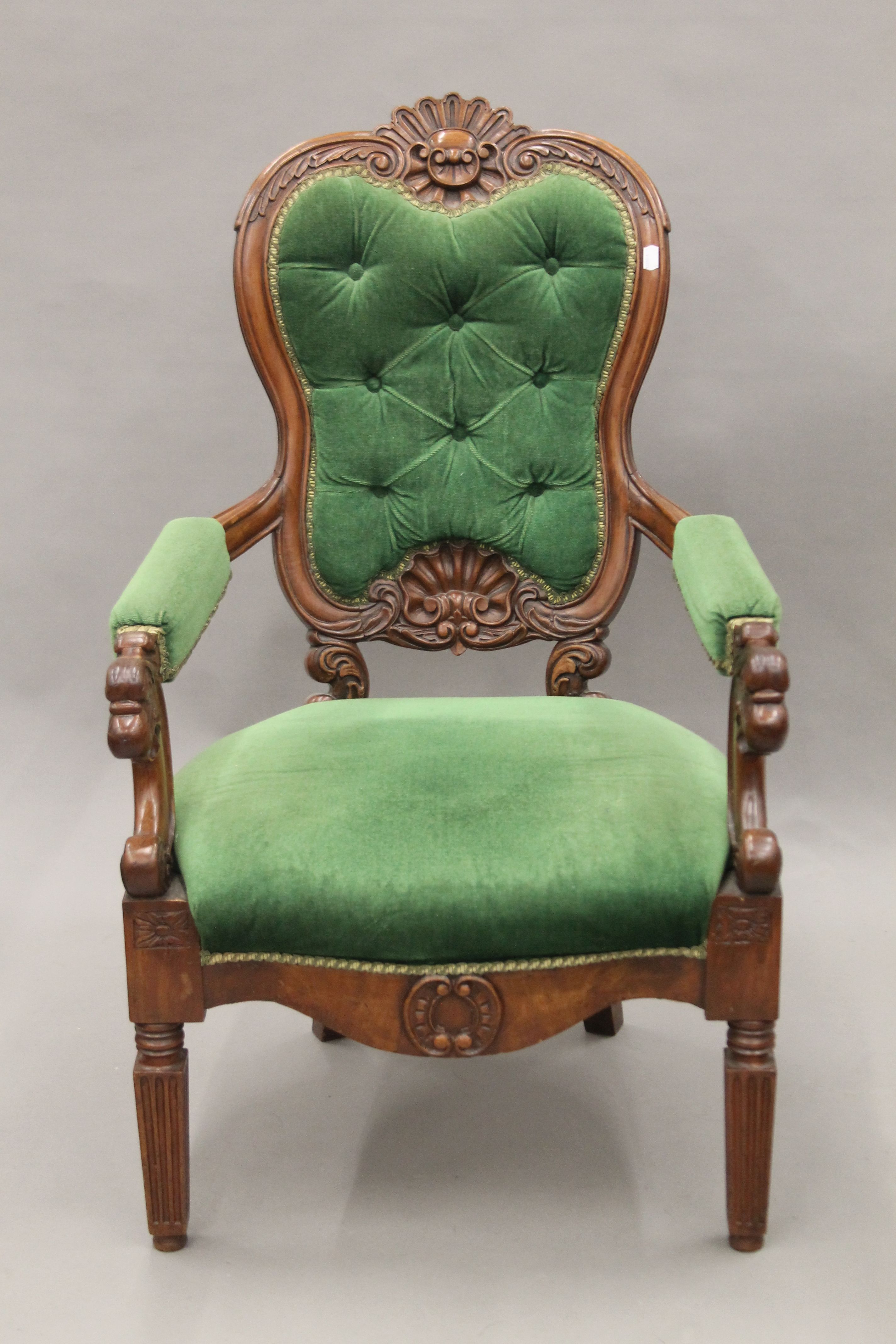 A 19th century mahogany carved open armchair. 59 cm wide.