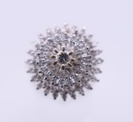 An 18 ct white gold diamond cluster ring. Ring size O. 6.3 grammes total weight.