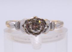 An 18 ct gold and platinum diamond solitaire ring. Ring size J/K. 2 grammes total weight.