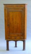 A George III inlaid oak corner cupboard on stand. 77.5 cm wide.