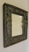 A carved oak framed mirror. 57 cm wide.