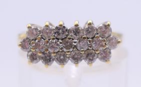 An 18 ct gold three row diamond ring. Ring size N/O.