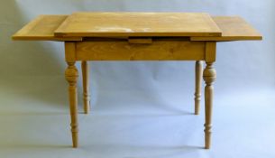 A modern pine drawer leaf table. 204 cm long extended x 80 cm wide.