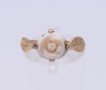 A 9 ct gold and coral florally set ring. Ring size J.