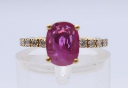 An 18 ct gold ruby and diamond ring. Ring size I.