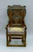 An 18th century carved oak open armchair. 55 cm wide.
