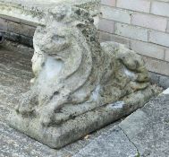 A composite recumbent lion garden statue. 52 cm high.