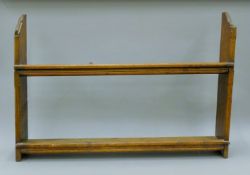 A Victorian carved oak wall shelf. 94 cm wide.