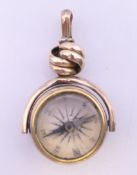 A 9 ct gold fob compass. 3.75 cm high. 6.9 grammes total weight.