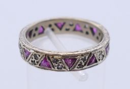 A 9 ct white gold gem set full eternity ring. Ring size P/Q. 4.8 grammes total weight.