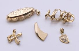 Five 9 ct gold pendants, including a locket. The locket 3.25 cm high. 12.1 grammes total weight.