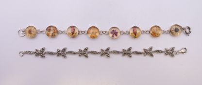 Two silver bracelets. Each approximately 18 cm long.