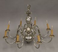 An eight-branch silvered brass chandelier. 62 cm high.