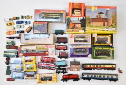 A collection of 00 gauge model railway rolling stock items, buildings and cars including