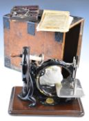 Late 19th or early 20thC Willcox & Gibbs sewing machine, in pine carry case with hinged handle to