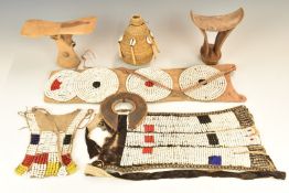 A collection of tribal beaded items and headrests from Turkana Kenya