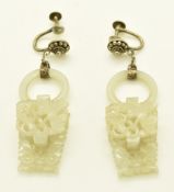 A pair of Chinese silver earrings set with a jade ring and carved jade drop section depicting