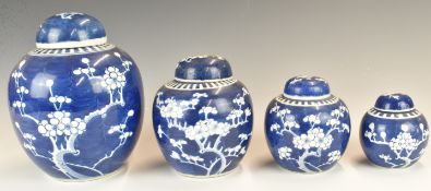 Chinese blue and white set of four graduated ginger jars with prunus decoration, tallest 19cm