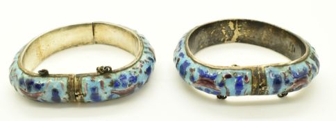A pair of Chinese silver bangles set with enamel depicting auspicious symbols, diameter 7.5cm,